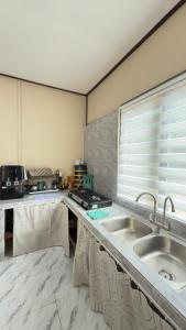 a kitchen with two sinks and a window at Perhentian Chatek Family Inn in Perhentian Islands +47 photos