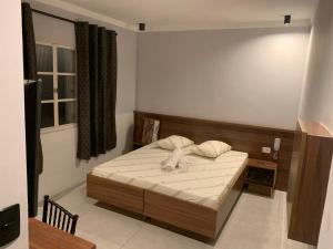 a small bedroom with a bed with white sheets at Hotel Maya in São Paulo +10 photos