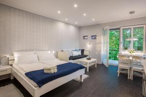 a bedroom with a bed and a table and a kitchen at Apartmaji Koman in Bled