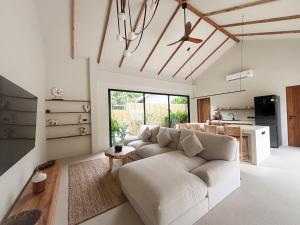 a living room with a couch and a table at K Villas Phangan 03 in Ko Phangan