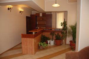 a lobby with potted plants and a reception desk at Hotel Kibor in Gŭlŭbovo