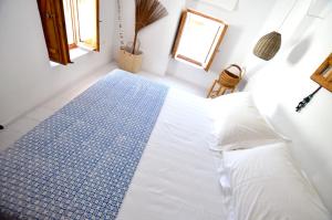 A bed or beds in a room at Lindos Esel Suites