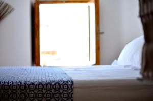 A bed or beds in a room at Lindos Esel Suites
