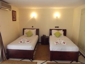 Postel nebo postele na pokoji v ubytování Hotel Al Kabir