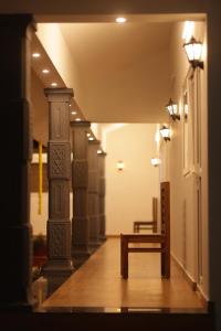 a hallway with a bench in a building at Marari Anns Casa Beach Homestay in Mararikulam