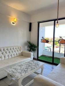 a living room with a white couch and a table at Luxurious apartments Mombasa in Mombasa