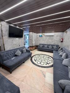 a living room with couches and a flat screen tv at Elaf Al bait ايلاف البيت in Mecca