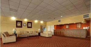 a large lobby with couches and chairs in a room at Americas Best Value Inn & Suites Greenville in Greenville +1 photo