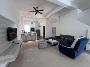 a living room with a couch and a ceiling fan at Bentong Fun Homestay in Bentong