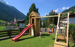 two children playing on a playground with a slide at Pension Sonnleitn in Neustift im Stubaital