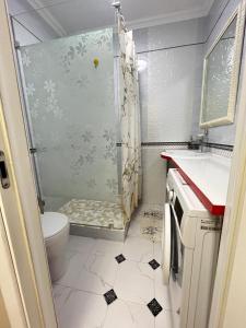 a bathroom with a shower and a toilet and a sink at Ush Sunkar Best in Almaty in Almaty +6 photos