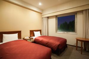 Postel nebo postele na pokoji v ubytování Narita Gateway Hotel