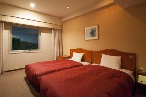 Postel nebo postele na pokoji v ubytování Narita Gateway Hotel
