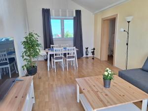 a living room with a couch and a table at Haus an der Steinbachtalsperre in Euskirchen