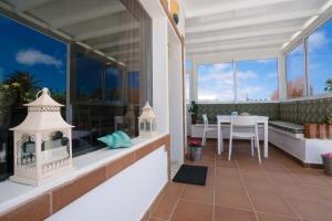 a balcony of a house with a table and chairs at Villa Pippa in Puerto del Carmen