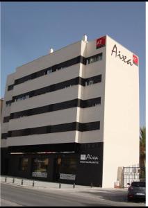 a large building with aania on the side of it at Apartamentos Aixa II in Caravaca de la Cruz