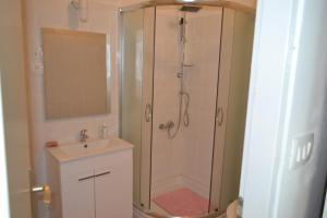 a bathroom with a shower and a sink at Apartments Martinis in Vis +25 photos