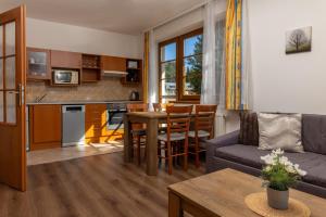a living room with a couch and a table at Apartmany Aneta in Špindlerův Mlýn