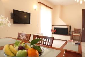 a bowl of fruit on a table in a living room at Evridiki's Villas in Agios Nikitas