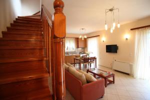 a living room with a staircase and a living room at Evridiki's Villas in Agios Nikitas