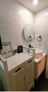 a bathroom with a sink and a mirror at Modern Elegance Escape in Azure North Bali Tower near Malls, Airport and NLEX in San Fernando