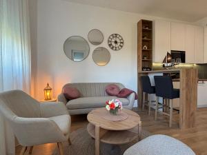 a living room with a couch and a table at Apartment Aqua Serena in Palić