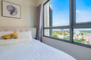 a bedroom with a white bed and two windows at Masteri Thao Dien Riverside Apartment in Ho Chi Minh City +102 photos
