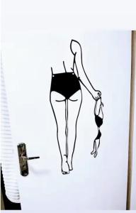 a drawing of a woman in a dress on a wall at Quartos em Jardim da Penha in Vitória +46 photos