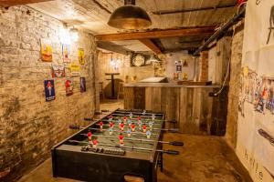 a ping pong table with balls on it in a room at Maison Victor - gîte 8 personnes dans le centre de Durbuy in Durbuy