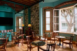 a room with tables and chairs and a tv at TUI BLUE Atlantic Hills in Puerto de la Cruz