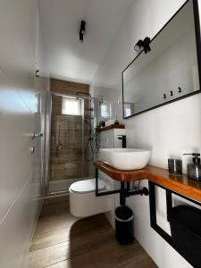 a white bathroom with a sink and a shower at Villa Marica & Joso in Drage