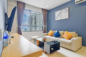 a living room with a couch and a table at The Vista Masteri Thao Dien N-Stay Apartment in Ho Chi Minh City