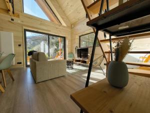 a living room with a couch and a table at Lodge de la WEISS in Lapoutroie