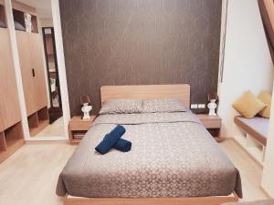 a bedroom with a bed with a blue object on it at La casita hua hin in Hua Hin