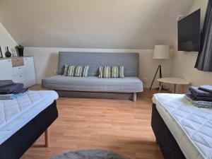 a living room with two beds and a couch at Litet och mysigt semesterboende in Ystad