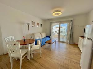 a kitchen and dining room with a table and a couch at Gregal - Castell Sol - Arenal de Castell in Arenal d'en Castell +15 photos