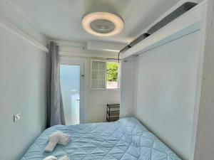 a bedroom with a bed with a towel on it at Gregal - Castell Sol - Arenal de Castell in Arenal d'en Castell