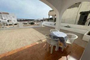 a patio with a table and chairs on a roof at Gregal - Castell Sol - Arenal de Castell in Arenal d'en Castell