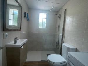 a bathroom with a shower and a toilet and a sink at Gregal - Castell Sol - Arenal de Castell in Arenal d'en Castell