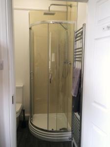 a shower with a glass door in a bathroom at INGRAM ARMS HOTEL, HATFIELD in Doncaster