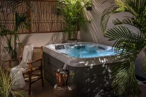a hot tub in a room with plants at Theatro Living in Elegance - Luxury Apartments in Hersonissos in Hersonissos