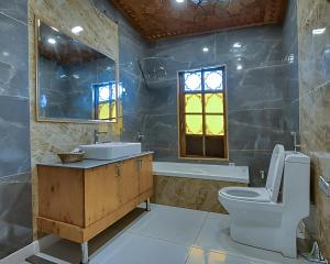 a bathroom with a toilet and a sink and a tub at The Royal hareem group of houseboats in Srinagar +23 photos
