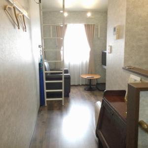 a small living room with a window and a chair at Apartment Hotel Mimoza - Vacation STAY 92095v in Sumoto
