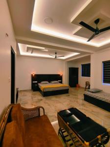 a bedroom with a bed and a couch in a room at Venattu Homestay in Thekkady