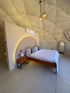 a bedroom with a large bed in a tent at Sunset Domes Premium in Bidiyah