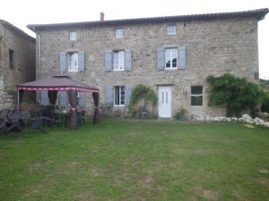 a large stone house with a gazebo in the yard at La Maison Des Badons in Saint-Basile