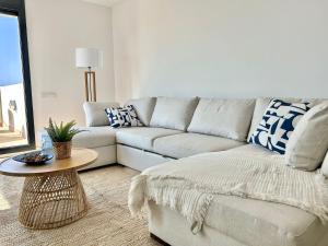 a living room with a couch and a table at Les Flors de Cunit Villa Liria in Cunit +49 photos
