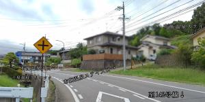 an empty road with a sign on the side of the road at 布施温泉ステイ　イースト in Saku +4 photos