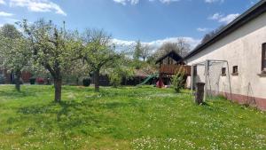 a green yard with trees and a playground at Fewo Gerda im schönen Odw in Mörlenbach