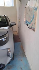 a car parked in a garage with a map on the wall at Ciranova 21 novi sad in Novi Sad